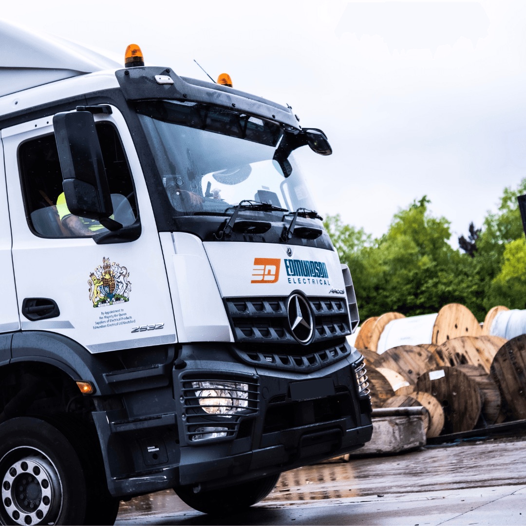 Edmundson Electrical delivery lorry beside cable drums
